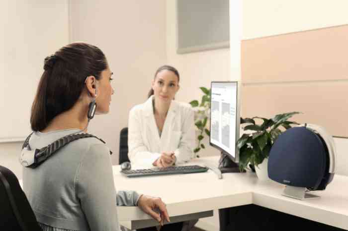 A woman during a hearing test with her NHC audiologist